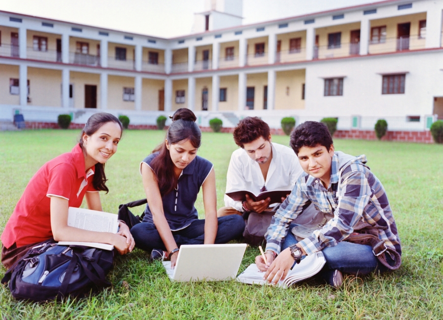 A group of Indian citizens sitting at a university campus.