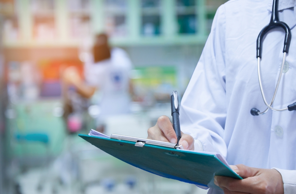 Doctor holding a clipboard at a clinic.