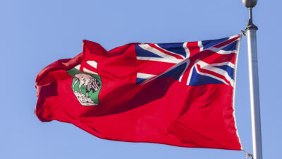 Manitoba flag against blue sky