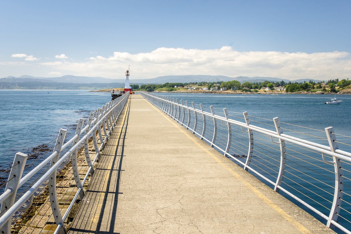 Fenced Catwalk on a Breakwater with a Lighthouse at the End in British Columbia.