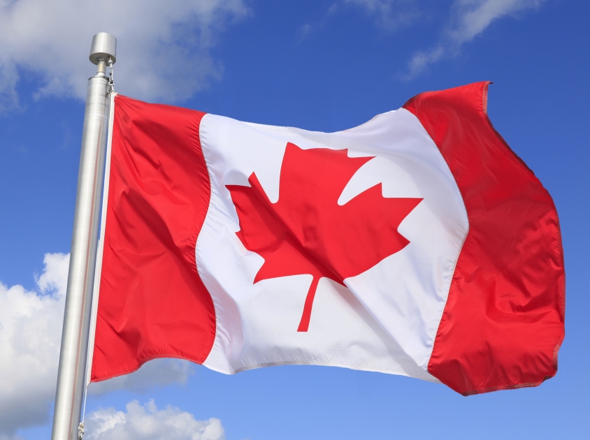 Canada flag 
 with mountain view on the background.